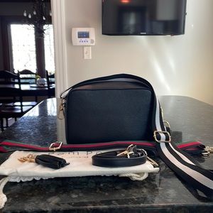 Pom Pom London black crossbody handbag.